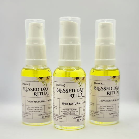 Three bottles of 'Blessed Day Ritual' on a gray background