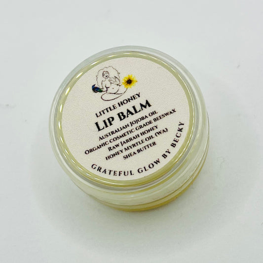 Lip balm container with 'Little Honey' branding on a white background