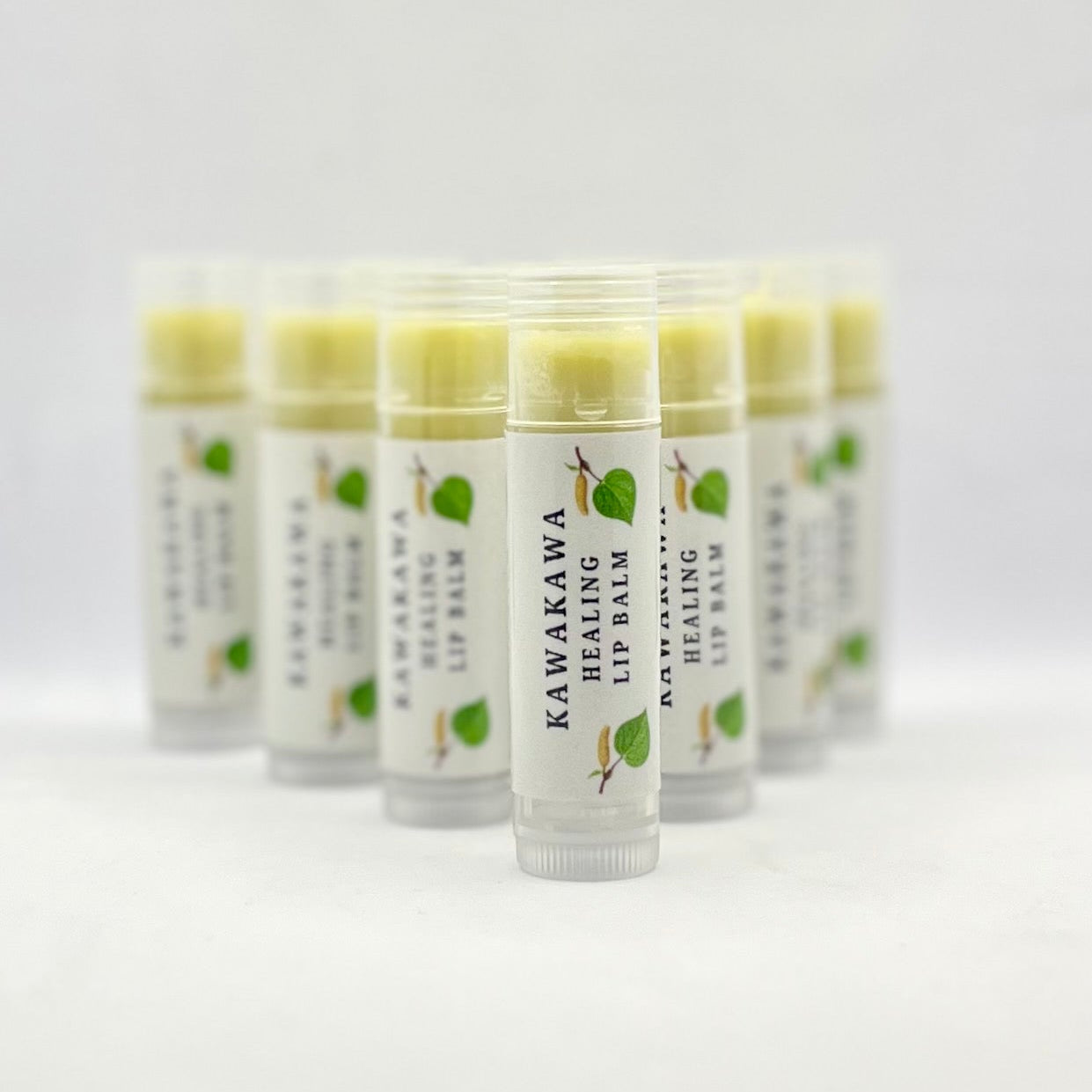 Row of lip balms on white background